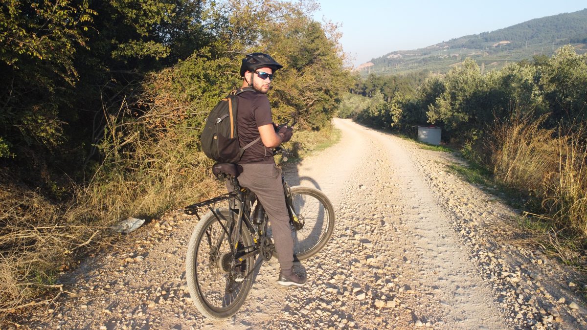 Ömer with a mountain bike on a gravel road